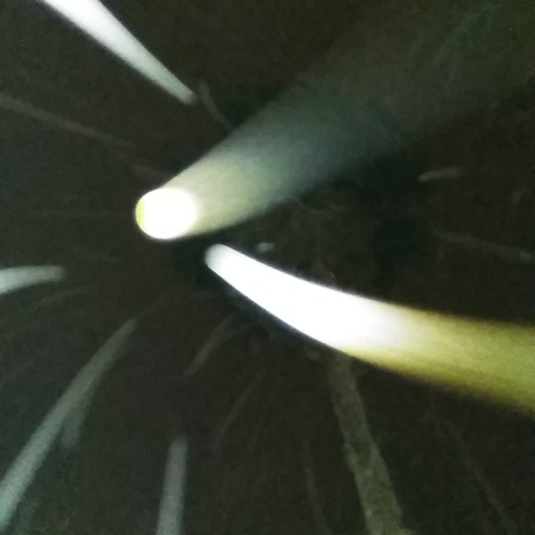 Abstract light streaks in dark tunnel.