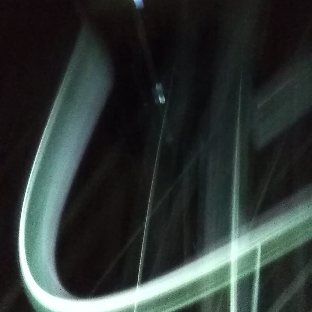 Blurred light streaks on a dark background.